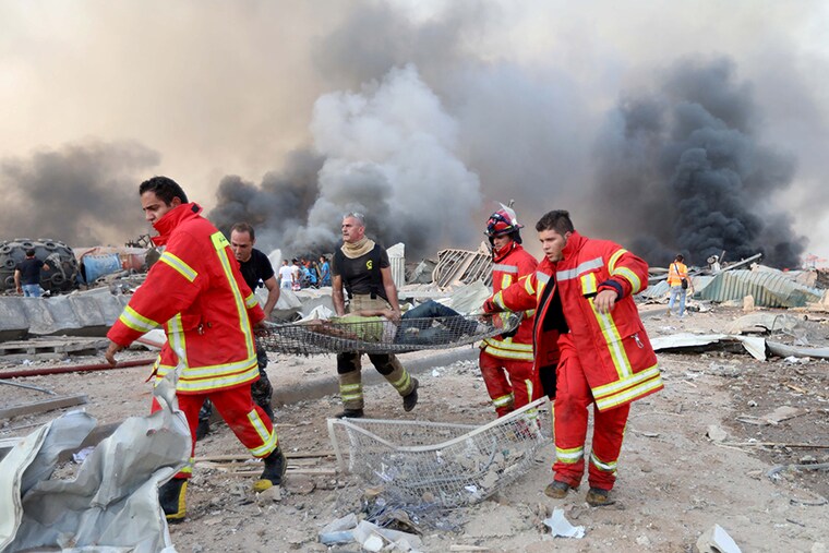 A man is evacuated at the site of an explosion in Beirut, Lebanon August 4, 2020.
