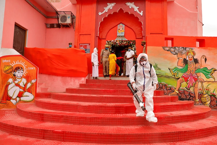 A municipal worker sprays disinfectant at Hanuman Garhi temple ahead of the foundation laying ceremony for a new Ram temple in Ayodhya.