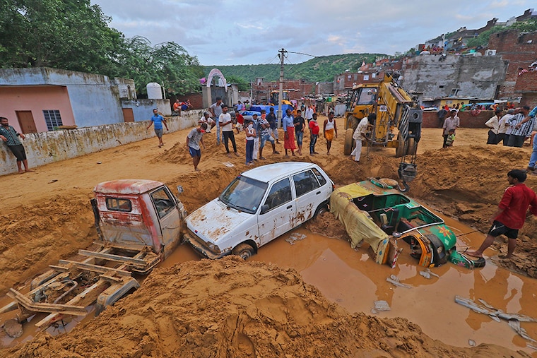 Vehicles buried in landslide rubble following heavy rainfall being salvaged at Sundar Nagar Ganesh Vihar colony, Lal Dungari, in Jaipur, Rajasthan, India, Aug 16,2020.