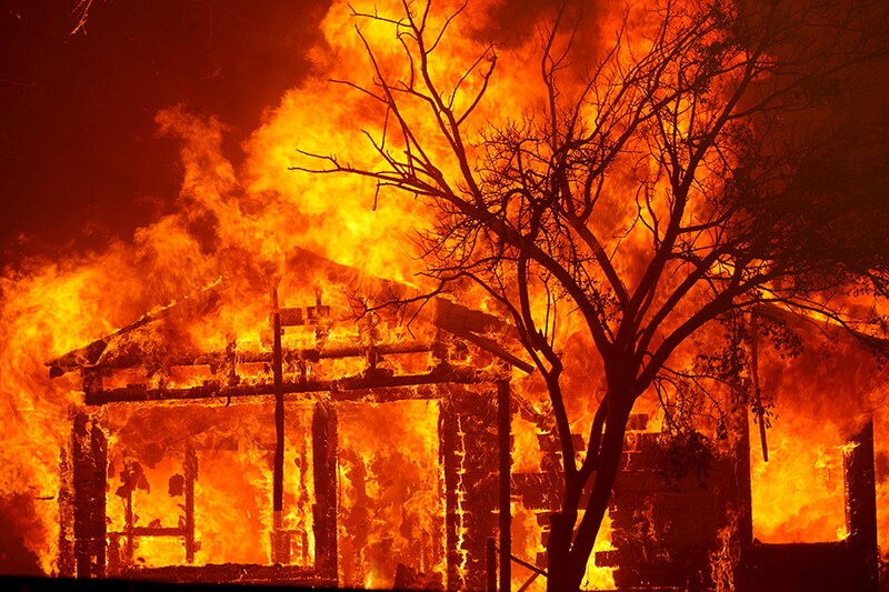 A burning home is seen along Cherry Glen Road during the LNU Lighting Complex Fire on the outskirts of Vacaville, California, U.S. August 19, 2020.
