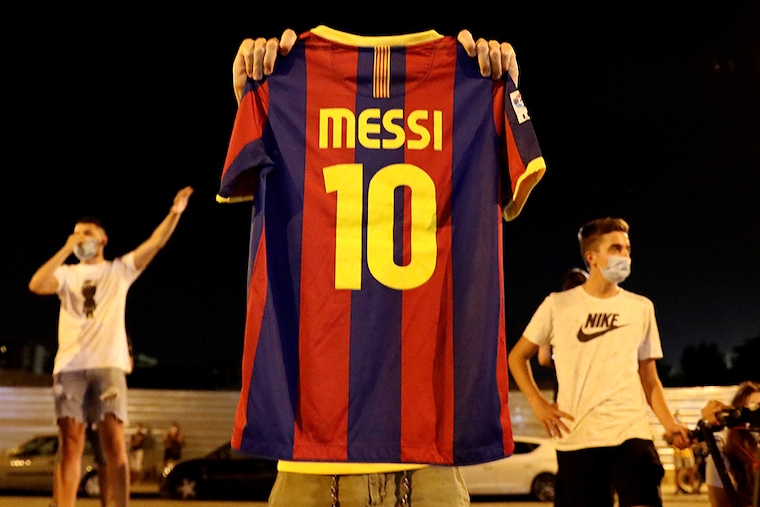 A Barcelona fan holds up a Lionel Messi shirt outside the Camp Nou after captain Lionel Messi told Barcelona he wishes to leave the club immediately, a source confirmed on Tuesday.