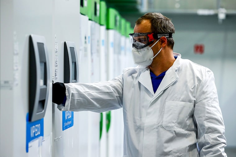 An employee opens an ultra-cold refrigerator filled with vaccines against the coronavirus disease at a secret storage facility in the Rhein-Main area, Germany, December 4, 2020.