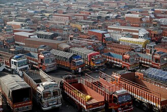 A man walks inside a truck terminal during a nationwide strike to protest against newly passed farm bills in Mumbai, India, December 8, 2020.