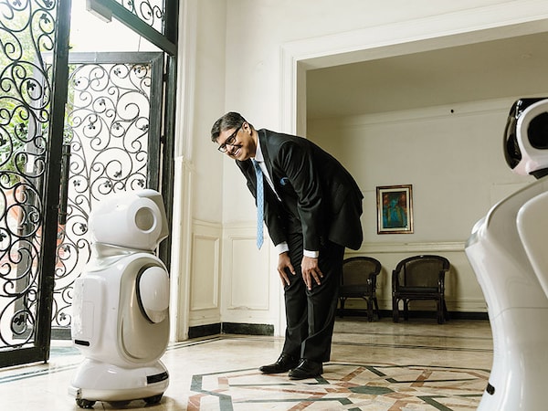 Rajeev Karwal, founder & chairman, Milagrow HumanTech, with humanoid robots RoboNano (facing him) and RoboELF that have been deployed in hotels and hospitalsImage: Madhu Kapparath