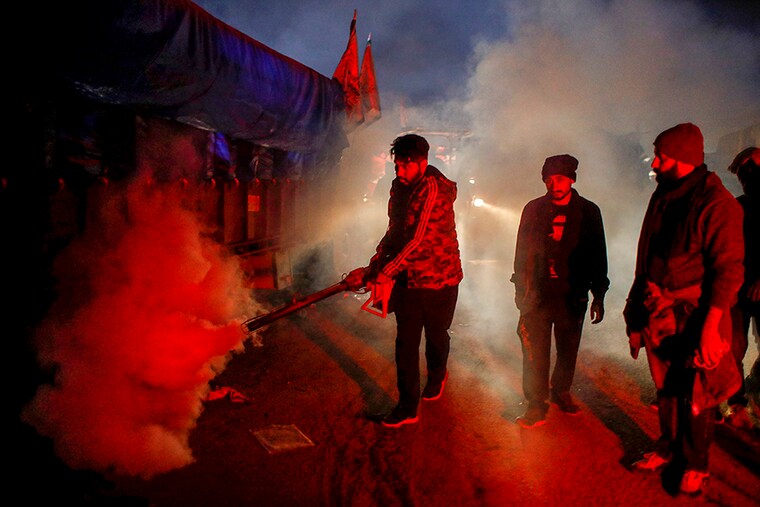 A man fumigates at a site of a protest against the newly passed farm bills at Singhu border near New Delhi, India, December 9, 2020.