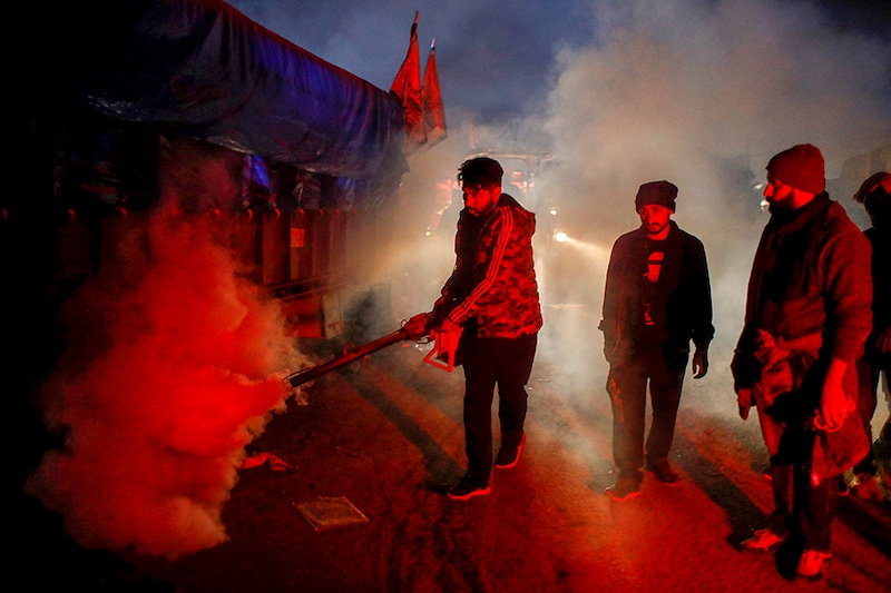 A man fumigates at a site of a protest against the newly passed farm bills at Singhu border near New Delhi, India, December 9, 2020.