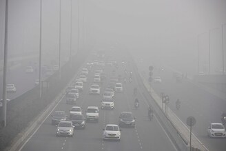 Vehicles ply amid heavy fog and cold weather conditions on NH-48 near IFFCO Chowk, in Gurugram, India. Delhi government will begin a limited drive in nine districts to check compliance of the order related to ensuring HSRP and colour-coded sticker for vehicles