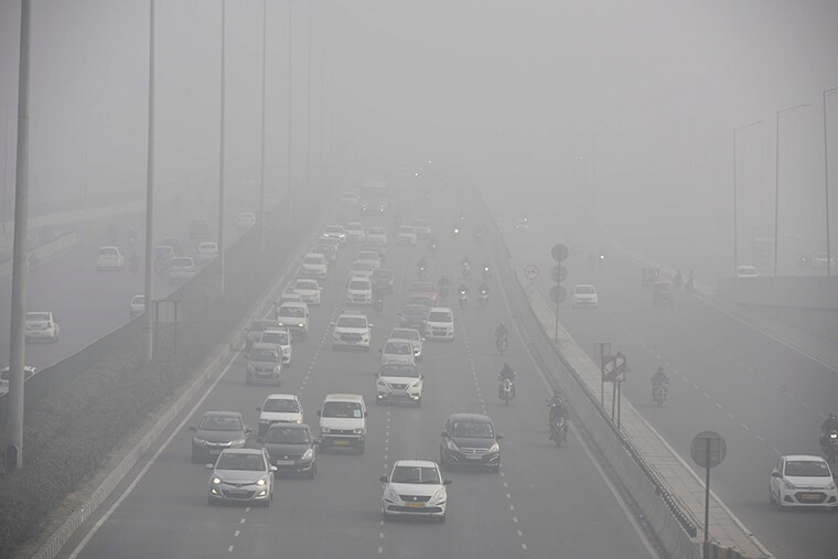 Vehicles ply amid heavy fog and cold weather conditions on NH-48 near IFFCO Chowk, in Gurugram, India. Delhi government will begin a limited drive in nine districts to check compliance of the order related to ensuring HSRP and colour-coded sticker for vehicles