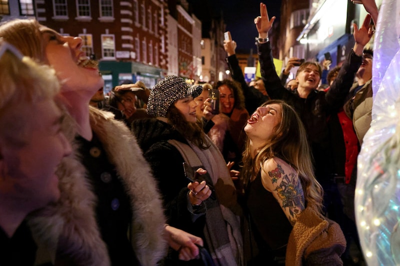People party on a street as pubs shut for the night due to tier 3 restrictions in Soho, as the spread of the coronavirus disease (COVID-19) continues in London, Britain, December 15, 2020.