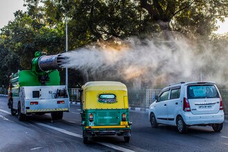 A municipal vehicle sprays disinfectant as part of measures to battle the Covid-19 coronavirus pandemic on December 16, in New Delhi, India. India currently has the largest number of confirmed cases in Asia and has the second-highest number of confirmed cases in the world after the United States. India on Wednesday recorded 26,382 fresh Covid-19 cases, taking the country"s total tally to 9.9 million according to the Union Health Ministry"s data. The active caseload of the country stands at 3,30,007. India has recorded less than 40,000 daily new cases since the last 17 days. The country"s death toll has mounted to 1,44,144.