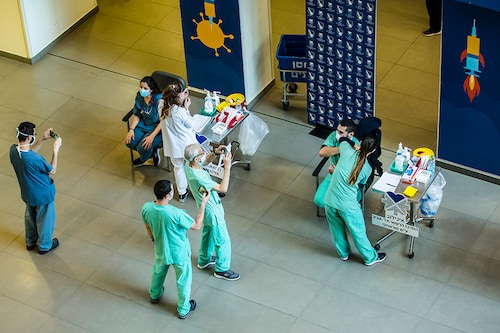 Medical workers vaccinate medical staff members against coronavirus (COVID-19) at Tel Aviv Sourasky Medical Center as Israel starts its COVID-19 vaccination campaign on December 20, 2020 in Tel Aviv, Israel. On Saturday night, Prime Minister Benjamin Netanyahu became the first Israeli to receive the approved Pfizer-BioNTech COVID-19 vaccine. The country of under 9 million people has reported 370,000 cases of the virus, with over 3,000 related deaths.