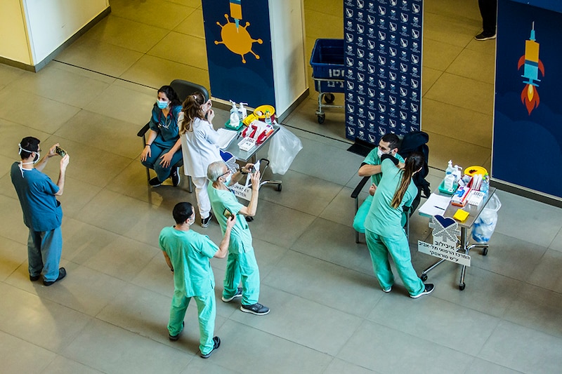 Medical workers vaccinate medical staff members against coronavirus (COVID-19) at Tel Aviv Sourasky Medical Center as Israel starts its COVID-19 vaccination campaign on December 20, 2020 in Tel Aviv, Israel. On Saturday night, Prime Minister Benjamin Netanyahu became the first Israeli to receive the approved Pfizer-BioNTech COVID-19 vaccine. The country of under 9 million people has reported 370,000 cases of the virus, with over 3,000 related deaths.