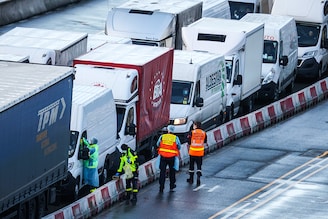 Members of the French Federation of Rescue and First Aid and the French Fire Service swab drivers to test for Covid-19 on December 24, 2020 in Dover, United Kingdom. Travel from the UK to France gradually resumed on Wednesday morning after being suspended for more than two days due to concerns about a new strain of Covid-19. The British government deployed its Track and Trace team to administer Covid-19 tests to lorry drivers waiting to cross at Dover.