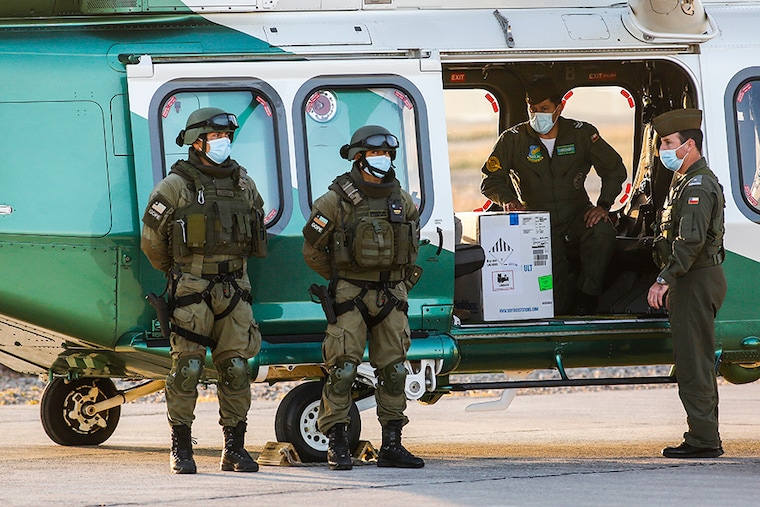 Soldiers transport the first batch of 10,000 doses of Pfizer/BioNTech vaccine for COVID-19 to Estadio Nacional at Arturo Merino Benítez on December 24, 2020 in Santiago, Chile.