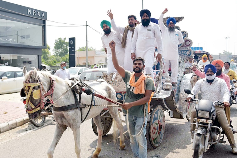 Shiromani Akali Dal (SAD) leaders and party workers on a horse cart in protest against the central and state governments over fuel price hikes as well as poor distribution of ration among the marginalized sections of society, at Golden Gate on July 7, 2020 in Amritsar, India.