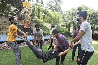 Students celebrate their results in the CBSE Class 12 boards examinations, at Geeta Bal Bharti Senior Secondary School at Gandhi Nagar on July 13, 2020 in New Delhi, India. The Central Board of Secondary Education (CBSE) on Monday declared the results for Class 12 examinations 2020. As per CBSE, with 88.78 per cent pass percentage this year for Class 12, the pass percentage has increased by 5.38 per cent. Last year, the pass percentage was 83.40 per cent.