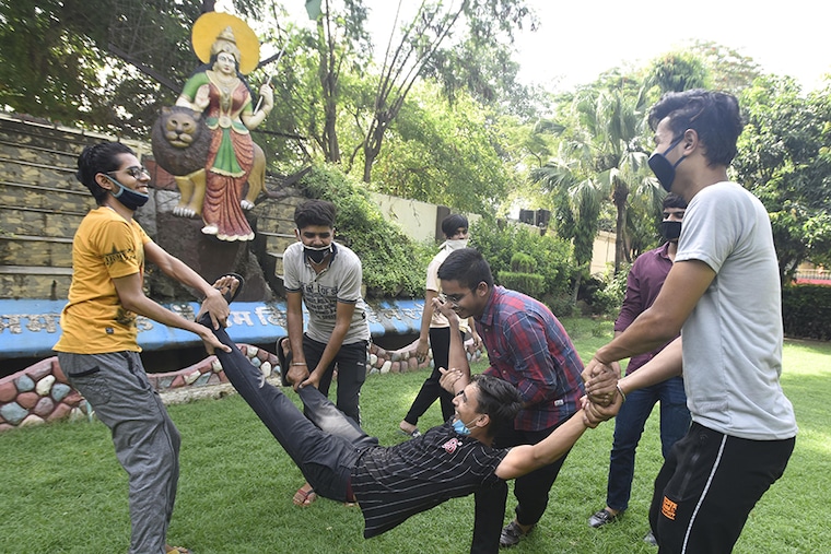 Students celebrate their results in the CBSE Class 12 boards examinations, at Geeta Bal Bharti Senior Secondary School at Gandhi Nagar on July 13, 2020 in New Delhi, India. The Central Board of Secondary Education (CBSE) on Monday declared the results for Class 12 examinations 2020. As per CBSE, with 88.78 per cent pass percentage this year for Class 12, the pass percentage has increased by 5.38 per cent. Last year, the pass percentage was 83.40 per cent.