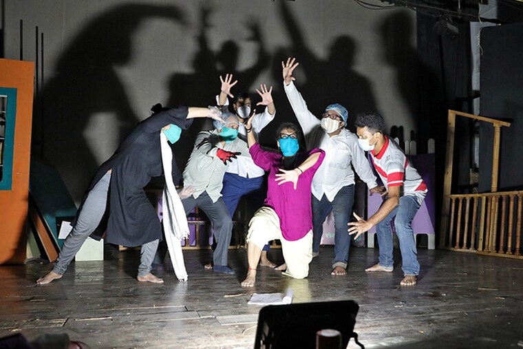 Actors wearing protective masks perform as they rehearse for "This Valley of Death is Not My Country" play at the Bidhan Auditorium, after authorities eased lockdown restrictions that were imposed to slow the spread of the coronavirus disease (COVID-19), in Kolkata, India, July 19, 2020.