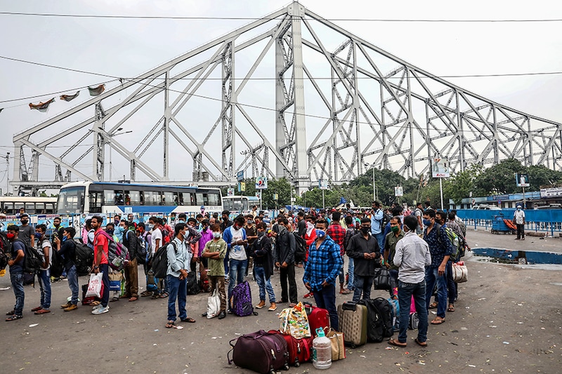Migrant workers wait in lines for transport outside the Howrah railway station after authorities announced lockdown for two days every week in the West Bengal state, amidst the spread of the coronavirus disease (COVID-19), in Kolkata, India, July 23, 2020.