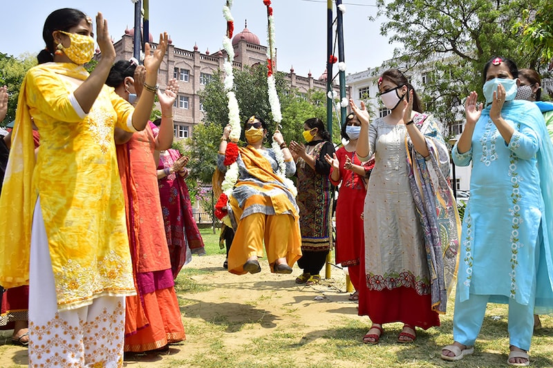 College teachers celebrate Teej festival to mark the month of Sawan, at Khalsa College for Women on July 28, 2020 in Amritsar, India.