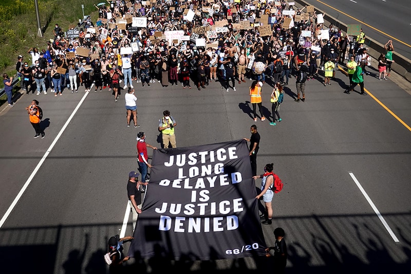 ST. PAUL, MINNESOTA - MAY 31: Demonstrators march on I-94 while participating in a protest against police brutality and the death of George Floyd on May 31, 2020 in St. Paul, Minnesota. Protests continue to be held in cities throughout the country over the death of Floyd, a black man who died while in police custody in Minneapolis on May 25.