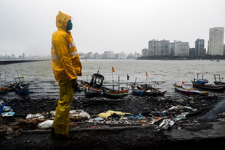 A Mumbai police official stands guard off the coast of the Arabian sea in Mumbai as cyclone Nisarga makes its landfall, on the outskirts of Mumbai, India, June 3, 2020