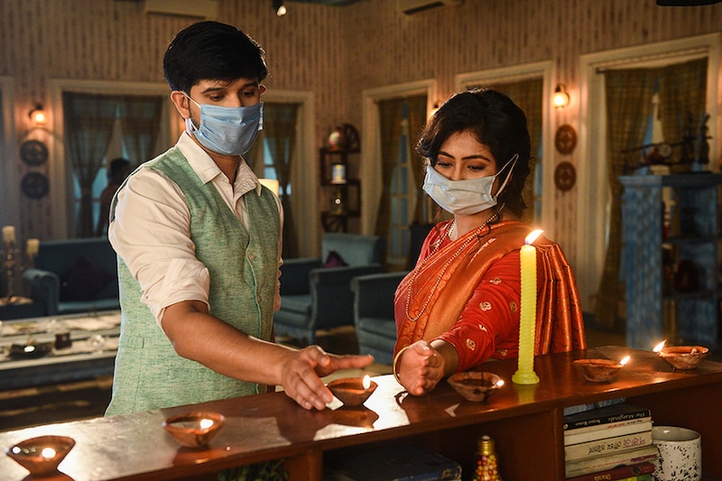 Actors Neel Bhattacharya and Tiyasha Roy rehearse a scene while wearing face masks during shooting for the popular Bengali television serial "Krishnakali", as production resumes during lockdown at Studio 13 at Tollygunge on June 11, 2020 in Kolkata, India