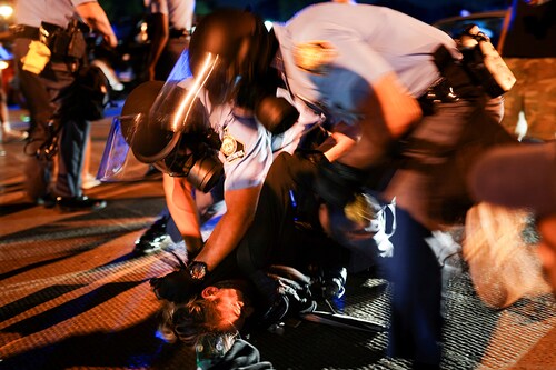Police detain protesters for blocking traffic during a rally against racial inequality and the police shooting death of Rayshard Brooks, in Atlanta, Georgia, U.S. June 13, 2020