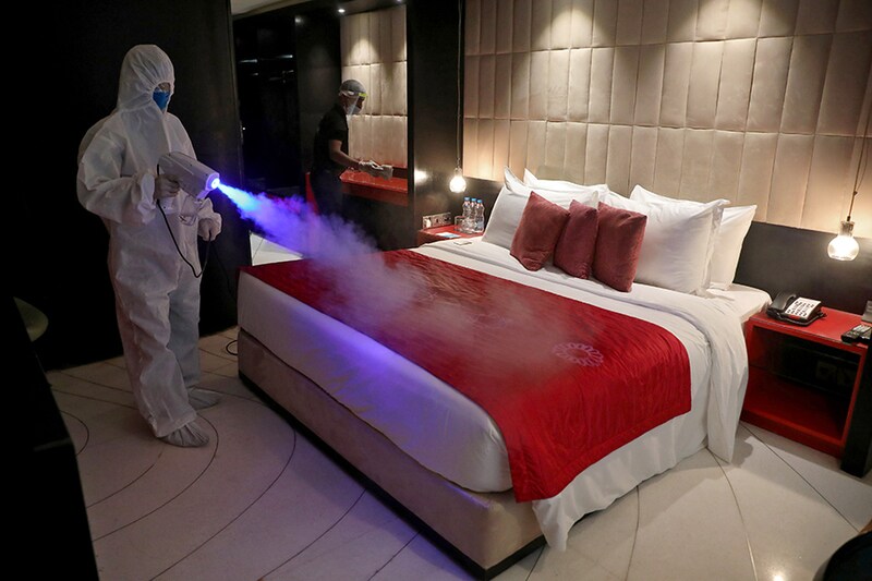 A worker wearing protective gear sanitizes a room at a hotel, after authorities eased lockdown restrictions that were imposed to slow the spread of the coronavirus disease (COVID-19), in Kolkata, India, June 15, 2020.
