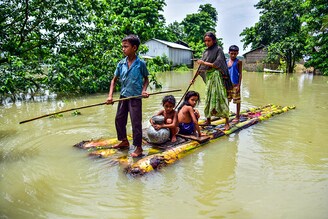 Villagers row a makeshift raft through a flooded field to reach a safer place at the flood-affected Mayong village in Morigaon district, in the northeastern state of Assam, India, June 29, 2020. â£â£