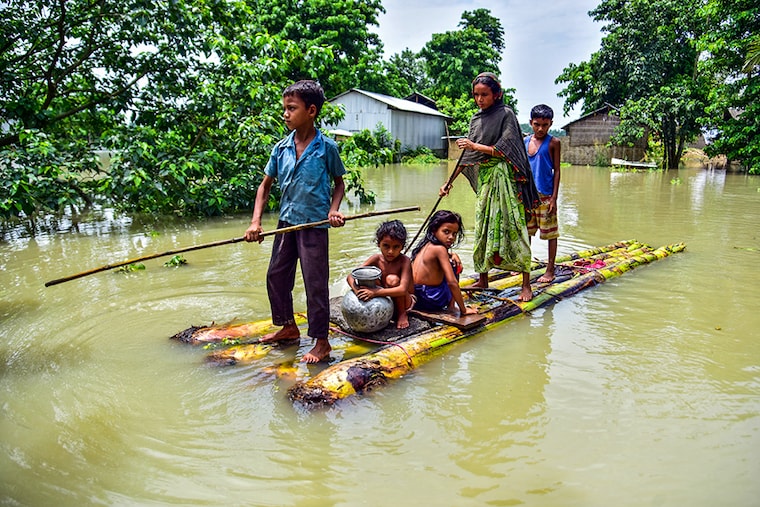 Villagers row a makeshift raft through a flooded field to reach a safer place at the flood-affected Mayong village in Morigaon district, in the northeastern state of Assam, India, June 29, 2020. â£â£