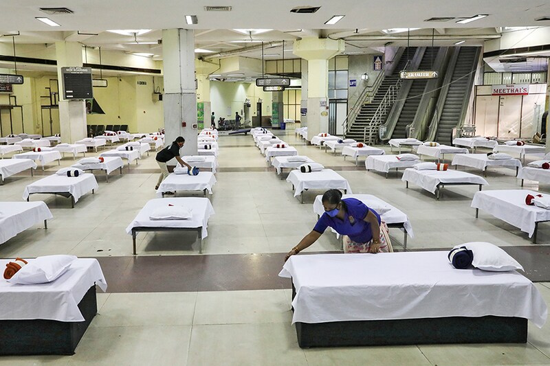 Housekeeping staff members prepare beds in a temporary quarantine facility for the incoming passengers inside a closed terminal building, at the Netaji Subhas Chandra Bose International Airport (CCU), after the government allowed domestic flight services to resume, during an extended nationwide lockdown to slow the spread of the coronavirus disease (COVID-19), in Kolkata, India, May 27, 2020