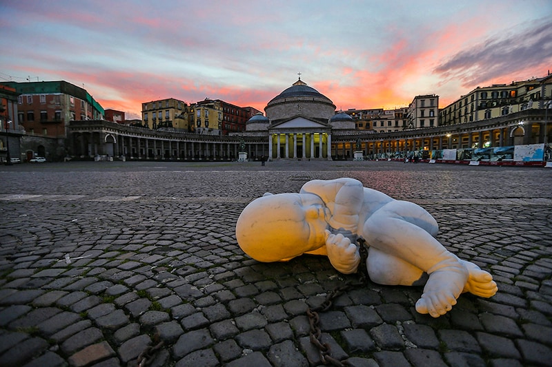 The sculpture of the artist Jacopo Cardillo, called Jago, entitled Look Down and depicting a fetus with a chain, installed in the center of Piazza Plebiscito in Naples, as a warning about the conditions in which the citizen lives today during the COVID-19 coronavirus pandemic.