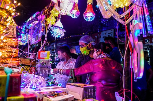 A couple shopping for decorative lights at a market in Kolkata. Citizens flock to markets to buy decorative lights for the upcoming Diwali festival in Kolkata, amidst rising cases of COVID-19. Kolkata records near to 1000 cases daily, with India edging towards 8.6 millions total infection counts.