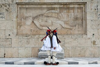 ATHENS, GREECE - NOVEMBER 22: Greek Presidential Guards, the Evzones, wear protective masks against the spread of coronavirus while performing their ceremonial duties at the Tomb of the Unknown Soldier on November 22, 2020 in Athens, Greece. Greek authorities aim to lift some of the current restrictions, which include the closure of schools and non-essential shops, when the lockdown expires on December 7. The lockdown was imposed on November 7 to curb a rise in covid-19 cases.