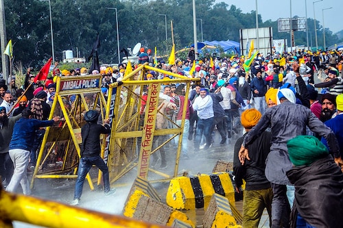 NOVEMBER 26: Members of various farmers organizations clash with police personnel while marching through Shambu Border during the Delhi Chalo protest against the new farm laws on November 26, 2020 in Patiala, India. Thousands of farmers clashed with cops and physically pushed vehicles as they were stopped by Haryana on their way from Punjab towards the capital in tractors and on foot for their two-day Delhi Chalo protest march against new farm laws that they fear will reduce their earnings and give more power to large retailers.