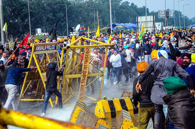 NOVEMBER 26: Members of various farmers organizations clash with police personnel while marching through Shambu Border during the Delhi Chalo protest against the new farm laws on November 26, 2020 in Patiala, India. Thousands of farmers clashed with cops and physically pushed vehicles as they were stopped by Haryana on their way from Punjab towards the capital in tractors and on foot for their two-day Delhi Chalo protest march against new farm laws that they fear will reduce their earnings and give more power to large retailers.