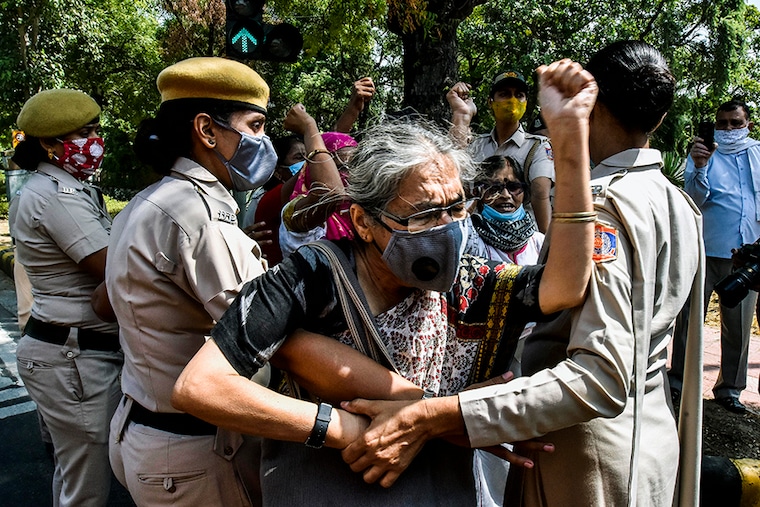 Police detained AIDWA activists as the protest against Hathras gang rape case at UP Bhavan on September 30, 2020 in New Delhi, India. Protestors demanded justice for Hathras gang-rape victim and resignation of Uttar Pradesh Chief Minister Yogi Adityanath. The 19-year-old girl was gang-raped by four men on September 14 in Hathras, when she went to gather fodder for her cattle. She succumbed to injuries on morning of September 29 at Safdarjung Hospital in Delhi. Family has accused the police of performing her last rites without their consent in the wee hours of September 30.