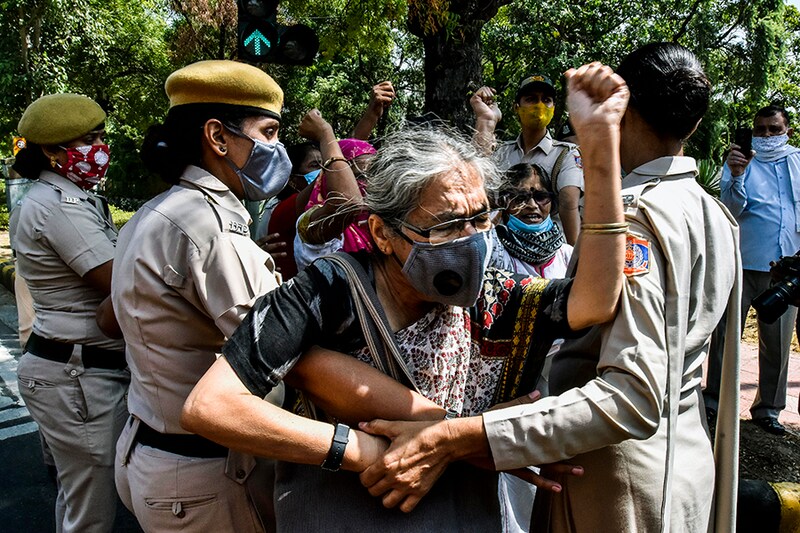 Police detained AIDWA activists as the protest against Hathras gang rape case at UP Bhavan on September 30, 2020 in New Delhi, India. Protestors demanded justice for Hathras gang-rape victim and resignation of Uttar Pradesh Chief Minister Yogi Adityanath. The 19-year-old girl was gang-raped by four men on September 14 in Hathras, when she went to gather fodder for her cattle. She succumbed to injuries on morning of September 29 at Safdarjung Hospital in Delhi. Family has accused the police of performing her last rites without their consent in the wee hours of September 30.