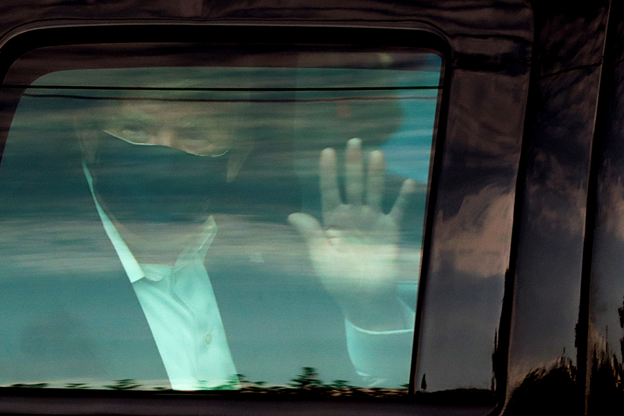 U.S. President Donald Trump waves to supporters as he briefly rides by in the presidential motorcade in front of Walter Reed National Military Medical Center, where he is being treated for coronavirus disease (COVID-19) in Bethesda, Maryland, U.S. October 4, 2020.
