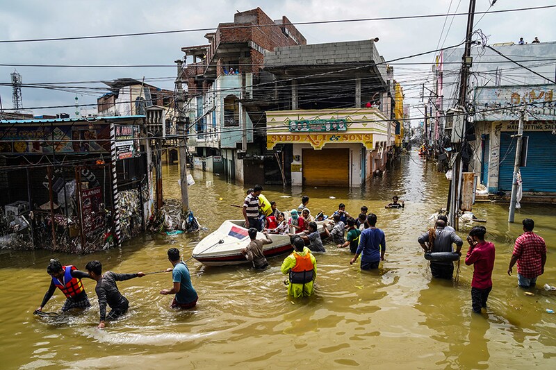 Residents are evacuated from a flooded neighbourhood after heavy rainfall in Hyderabad, the capital of the southern state of Telangana, India, October 15, 2020.