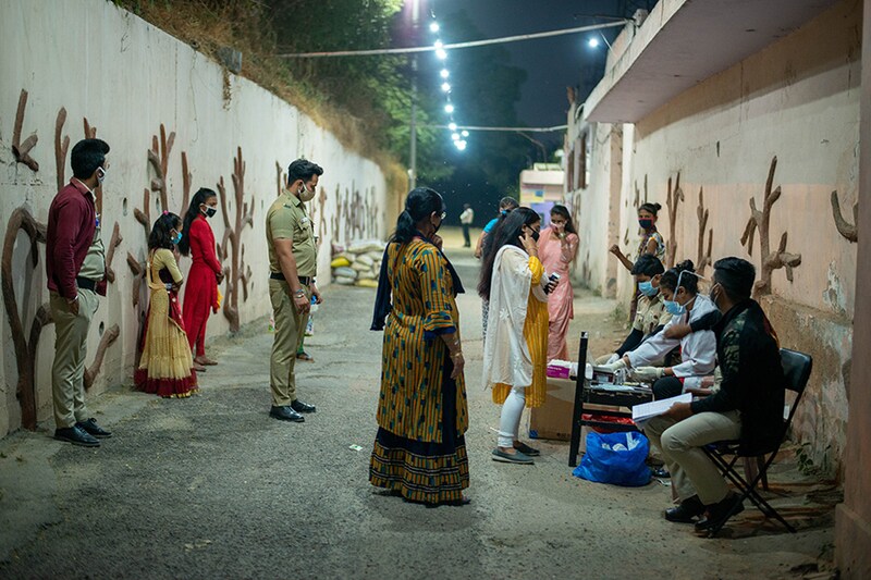 People waiting in a queue for mandatory coronavirus rapid tests, conducted on all devotees coming into the temple for worship during the Navratri Nights at Preet Vihar.
