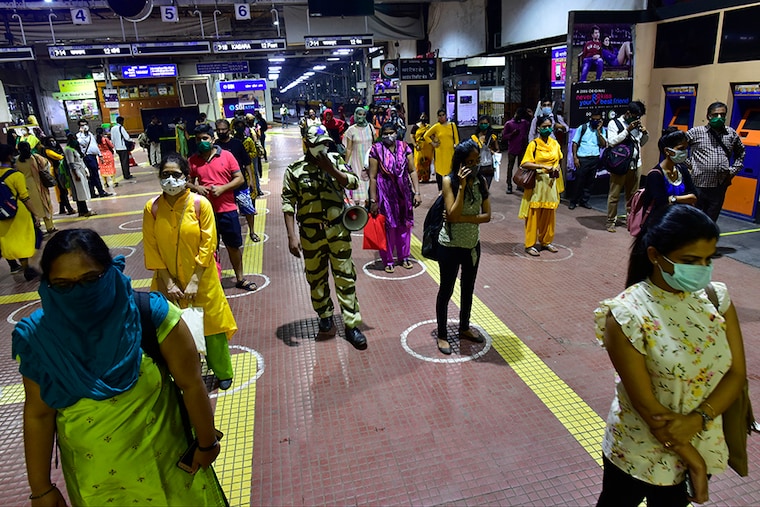 Commuters stand in queue for tickets and monthly pass at CSMT, on October 22, 2020 in Mumbai, India.