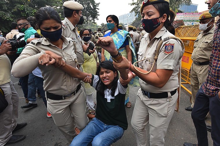 Delhi Police officials detain an Aam Aadmi party worker during a protest against privatisation of sanitation services by South Delhi Municipal Corporation (SDMC), outside the Civic Center, on October 28, 2020 in New Delhi, India. Four AAP MLAs and other party leaders were booked under various IPC sections after the police alleged that they manhandled a senior police officer and nine other personnel, including women constables, during a protest organised at the Civic Centre in central Delhi.