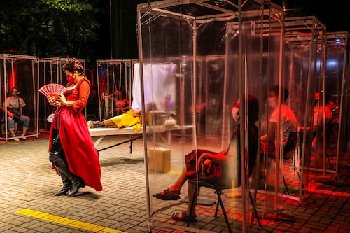 Spectators keep social distance inside individual plastic cabins as they watch the theatre play "Volpone Protocol" staged by Bendita Trupe during the coronavirus disease (COVID-19) outbreak in Sao Paulo, Brazil October 28, 2020.