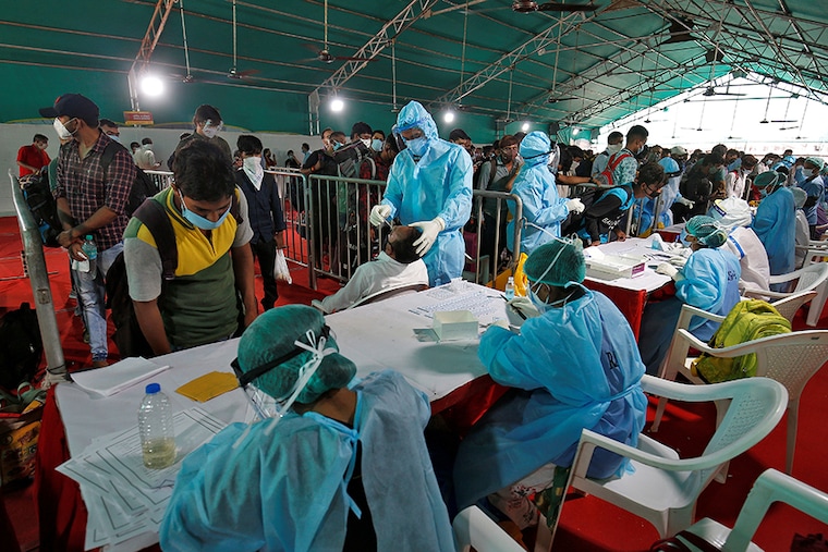 Passengers get their travel details recorded at registration counters before giving their swabs for rapid antigen tests upon their arrival at a railway station, amidst the coronavirus disease (COVID-19) outbreak, in Ahmedabad, India, September 8, 2020.