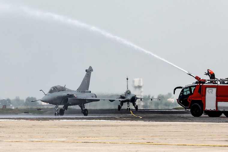 Rafale fighter jets receive a water cannon salute during its induction ceremony at an air force station in Ambala, India, September 10, 2020.