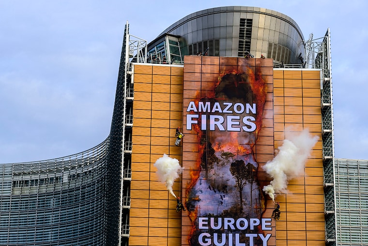 Greenpeace activists unveil a banner on the European Commission building to protest on the Amazon rainforest wildfires, in Brussels, Belgium on September 11, 2020.