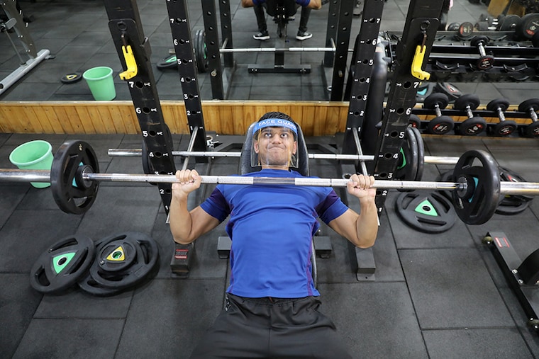 A man wearing a face shield trains in a gym which reopened after some restrictions were lifted, amidst the spread of the coronavirus disease (COVID-19), in New Delhi, India, September 14, 2020.