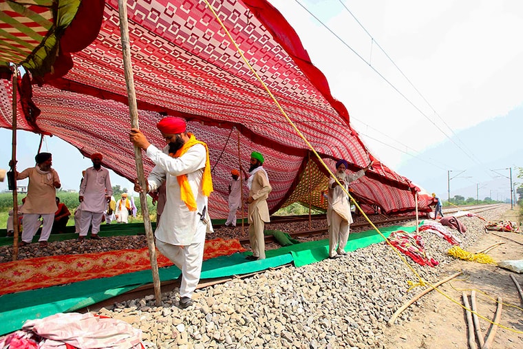 Farmers erect a temporary shade on railway tracks to take shelter from the sun as they block the rail tracks during a protest against farm bills passed by India"s parliament, in Devi Dasspura village on the outskirts of Amritsar, India, September 24, 2020.